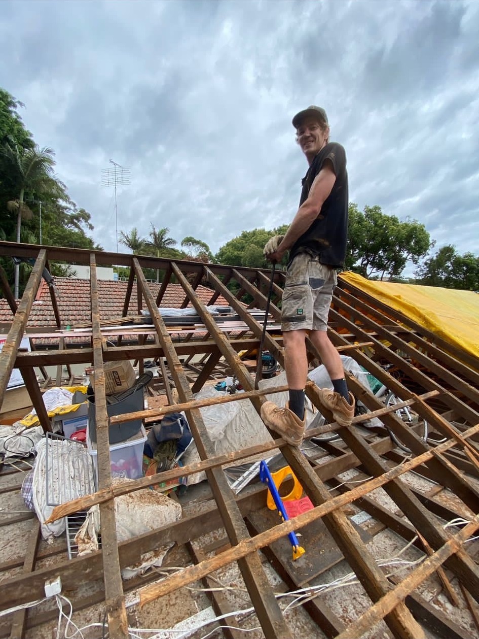 photo of Julian working on a roof
